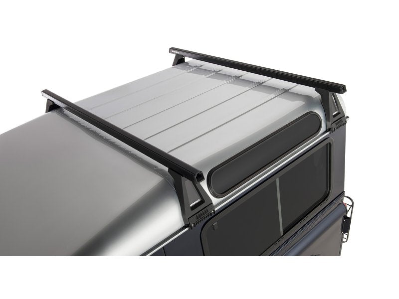 Kit 2 Dachträger-Querträger schwarz Heavy Duty 1500mm mit Füßen RL210 Land Rover Defender — Rhino Rack